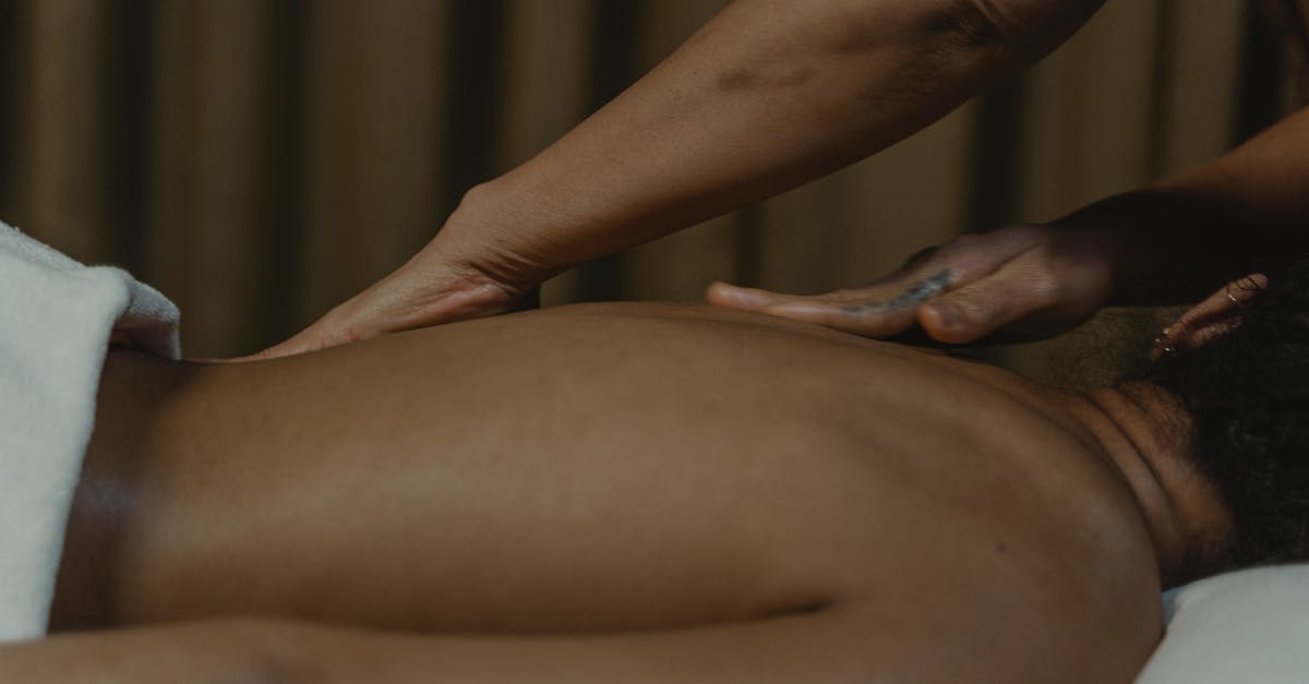 A calming spa massage with hands gently massaging a client's back for ultimate relaxation.